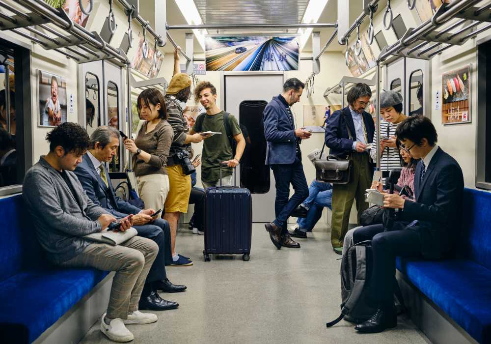 A group of people sitting on a subway train.
