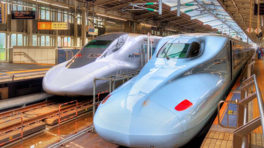 Two high-speed trains at a station platform.