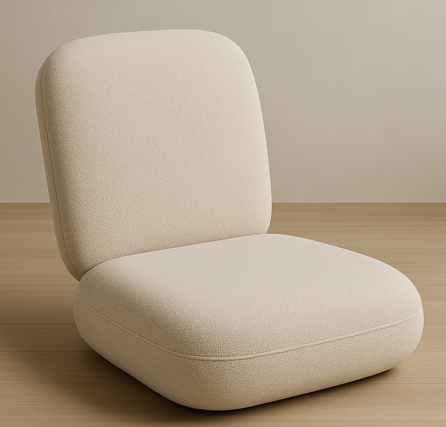 A minimalist, beige, cushioned chair with no arms on a wooden floor against a beige wall.