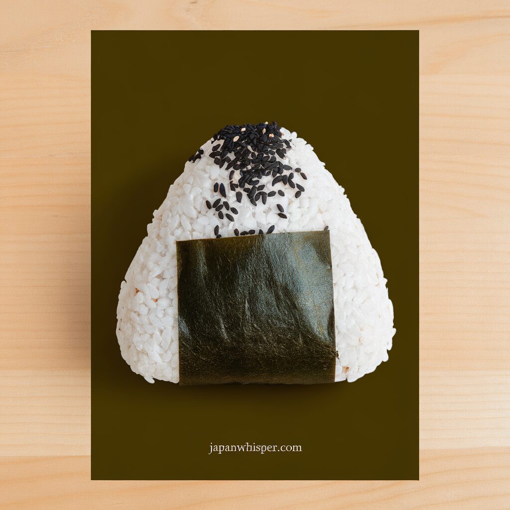 A triangular rice ball (onigiri) topped with black sesame seeds and wrapped with a strip of nori, placed on a dark green background.